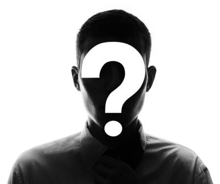 Man in shadow with question mark in front of his face